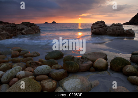 Sonnenuntergang über dem Meer gesehen von Porth Nanven, einem Strand, manchmal auch als "Dinosaurier-Ei-Beach" wegen großen Kaution in Höhe von Stockfoto