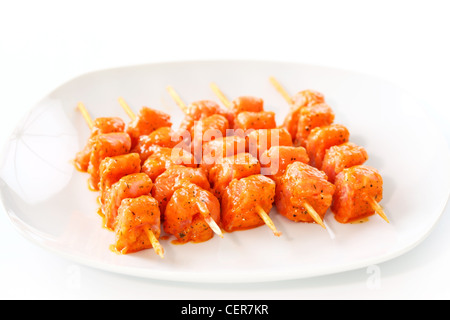 RAW aufgespießt mariniertes Huhn auf weißen Teller Stockfoto