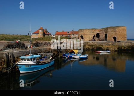 Kleine Boote in Beadnell Hafen und die Überreste des Kalks Brennöfen, die älteste stammt aus dem Jahr 1789. Stockfoto