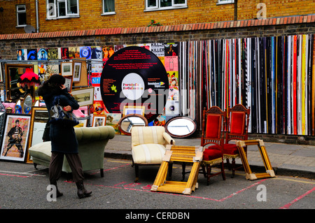 Möbel und Bilderrahmen zum Verkauf auf der Straße vor Portobello Erinnerung, eine Wand dekoriert als klassische Vinyl recor Stockfoto