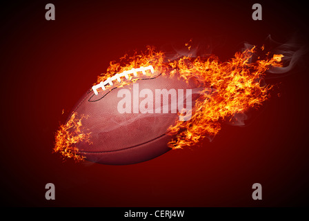 US-amerikanischer American-Football-Ball im Feuer isolierten auf dunkelroten Hintergrund