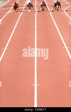 Laufstrecke, Sportler an der Startlinie in Ferne Stockfoto