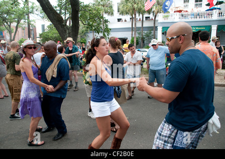 Einheimische Männer und Frauen tanzten auf einer Straßenparty während eines Lebensmittelfestivals in der Nähe des französischen Viertels von New Orleans in Louisiana, Vereinigte Staaten. Stockfoto