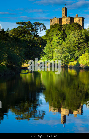 Warkworth Castle spiegelt sich in den stillen Wassern des Flusses Coquet. Stockfoto