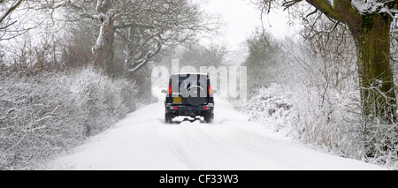 Land Rover Discovery getrieben entlang Schnee bedeckten Feldweg (verdeckt Nummer Platte & Händler Name entfernt) Stockfoto