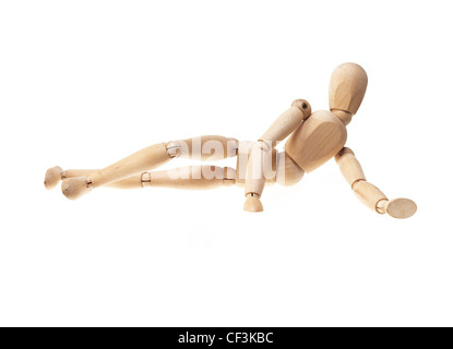 Holz Manneken Verlegung Onn Seite über weiß Stockfoto