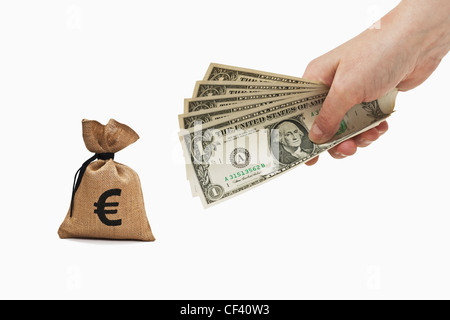 Fünf 1 US-Dollar Rechnungen werden in der Hand, in der Nähe von gehalten ist ein Geldbeutel mit Euro-Währung-Zeichen, weißen Hintergrund. Stockfoto