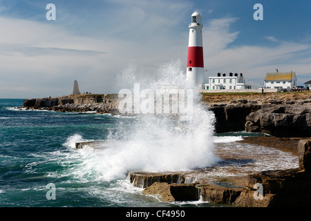 Wellen brechen über die Felsen von Portland Bill Lighthouse. Stockfoto