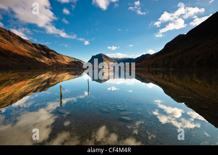 Die umliegenden Berge spiegeln sich in den ruhigen Gewässern des Buttermere-See. Stockfoto