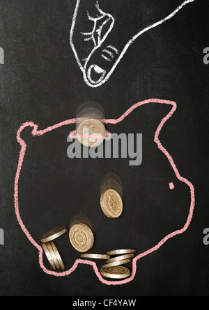 Kreide gezeichnete Hand fallenlassen echten Pfund Münzen in einem Chalk piggy Bank gezogen Stockfoto