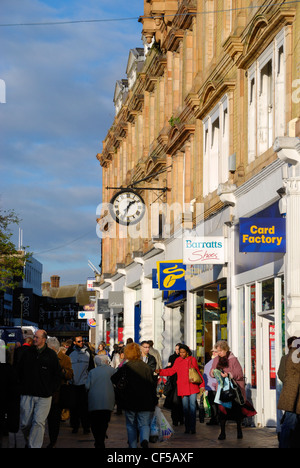 Käufer außerhalb Ladenfronten in Bromley High Street. Stockfoto