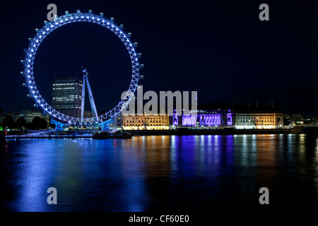 Das London Eye am Südufer der Themse in der Nacht. Stockfoto