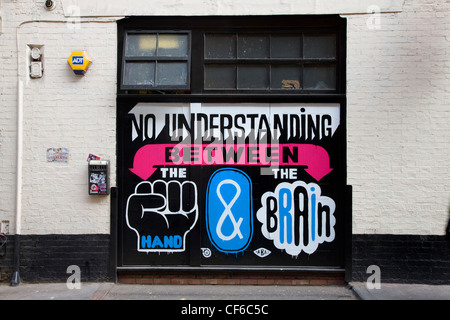 Graffiti und großen Text auf der Seite eines Gebäudes in Shoreditch entwickelt. Stockfoto