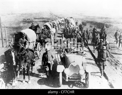 Deutsche Offiziere in einem Auto auf der Straße mit einem Konvoi der Wagen; Soldaten Fuß entlang die Straße, 1. Weltkrieg Stockfoto