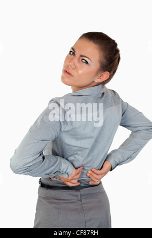 Porträt von eine junge Geschäftsfrau mit Rückenschmerzen Stockfoto
