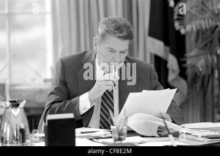 Ronald Reagan sitzt an seinem Schreibtisch im Oval Office Stockfoto
