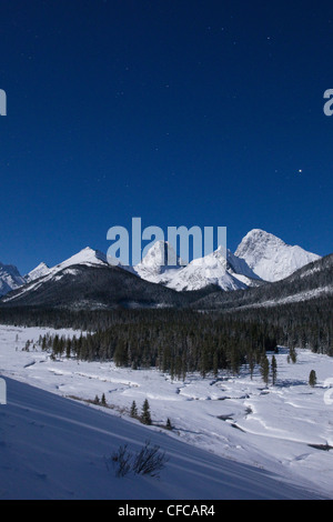 Die Rocky Mountains in einer Winternacht in Spray Valley Provincial Park in Kananaskis Country, Alberta von Vollmond beleuchtet. Stockfoto