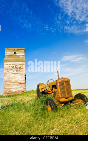 alten Traktor mit verlassenen Aufzug im Hintergrund, Dankin, Saskatchewan, Kanada Stockfoto