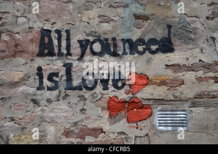 "All You Need Is Love" Graffiti an der Wand in Edinburgh und den Titel eines Beatles-Songs. Stockfoto