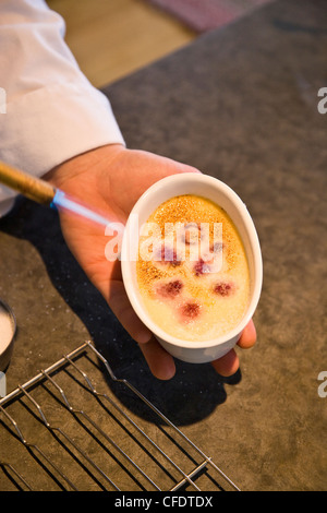 Karamellisieren Sie weiße Schokolade und Himbeer Creme Brule, Island Lake Lodge, Fernie, BC, Kanada. Stockfoto