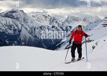 Ein Mann auf eine Backcountry-Ski-Tour im frühen Morgenlicht. Eisfall Lodge, Golden, British Columbia, Kanada Stockfoto