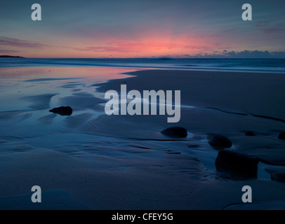 Die aufgehende Sonne hohe Lichter atmosphärischen Asche reisten von weit weg in Chile.  Corrimal Beach NSW Australia Stockfoto