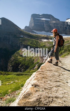 Eine Frau in ihren frühen dreißiger Jahren Wanderungen entlang des Weges Grinnell Gletscher im Glacier National Park, Montana. Stockfoto