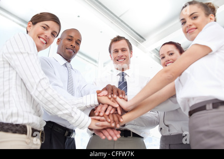 Lächelnd beantworte ihre Hände zusammen für eine Teamarbeit Geste Stockfoto