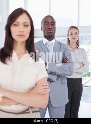 Zwei Kollegen, die ihre Gelenkarme, wie sie hinter ihrer Mitarbeiter stehen Stockfoto