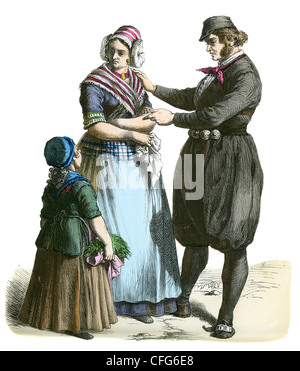 Ein paar mit einem kleinen Kind in der Tracht des niederländischen Country Folk des 19. Jahrhunderts Stockfoto