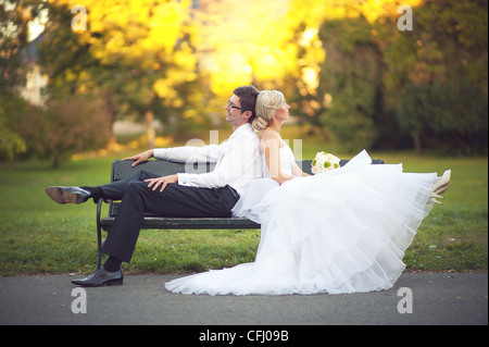 Braut und Bräutigam sich erholend in einem park Stockfoto