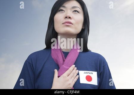 Junge Frau, die Unterstützung der Japan-Frauen-Fußball-Nationalmannschaft Stockfoto