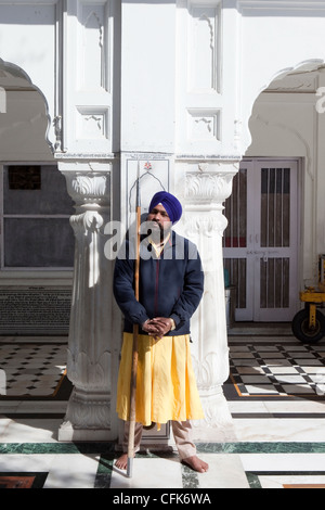 Ein Tempelwächter steht hält einen Speer auf seinem Posten bei Haramandir Sahib Komplex an der goldenen Tempel in Amritsar. Stockfoto