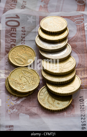 zehn Euro-Banknoten mit Euro-Münzen Stockfoto