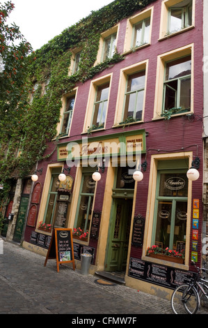 Vertikale Sicht auf ein Restaurant und Café auf einer gepflasterten Straße in Patershol, das gastronomische Herz und der älteste Teil von Gent. Stockfoto