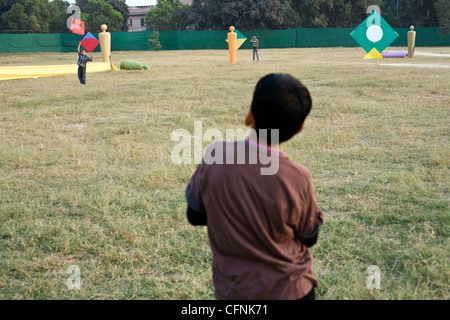 Ein Junge beobachtet andere Kinder Drachen fliegen während einer Drachenfliegen Festival am India Gate, Neu-Delhi Indien Stockfoto