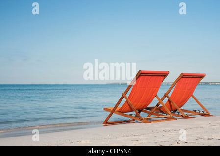 Leere Liegestühle am Strand Stockfoto