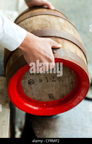 Brauer in seiner Brauerei ist traditionell ein Bierfass mit Teer Pech abdichten. Stockfoto