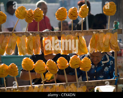 Antigua, Guatemala. 23.03.07 geschnittene frisch Früchte auf Sticks für Verkauf Kontrast mit westlichen alkoholfreie Getränke im Markt Stadt. Stockfoto