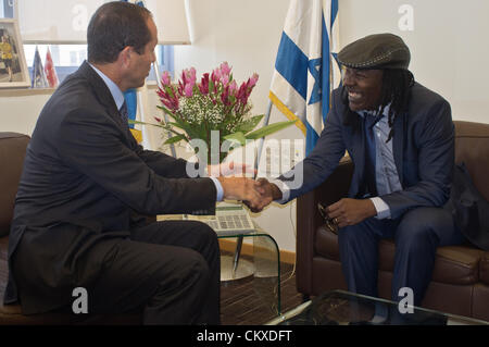 28. August 2012. Jerusalem, Israel. Austausch von Jerusalem Bürgermeister Nir Barkat und Reggae-Musiker Alpha Blondy Handschlagqualität und zahlreiche lächelt in das Büro des Bürgermeisters. Jerusalem Bürgermeister Nir Barkat begrüßt Alpha Blondy nach Jerusalem in seinem Büro im Rathaus, anlässlich des Blondy vierter Besuch in Israel. Alpha Blondy wird heute Abend auf dem Jerusalem-Reggae-Festival in Sacher Park führen. Stockfoto