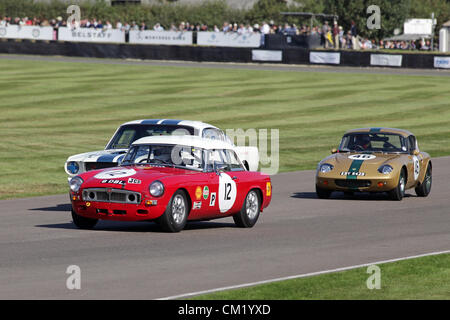 Goodwood Estate, Chichester, UK. 15. September 2012. Joe Bamford fahren ein 1963 MGB (Nr. 12) ist von Martin Stretton fahren seine 1964 Lotus 26R gejagt (Auto 62). Jeremy Cooke fahren ein weißes 1966 Ford Shelby Mustang GT350 ist teilweise im Hintergrund versteckt. Die Wiederbelebung ist eine "magische Schritt zurück in die Zeit", präsentiert eine Mischung aus Autos und Luftfahrt aus den 40's, 50er und 60er Jahre und ist eines der beliebtesten historischen Motorsport-Ereignisse in der Welt. Besuchen Sie für weitere Informationen www.goodwood.co.uk/revival. Stockfoto