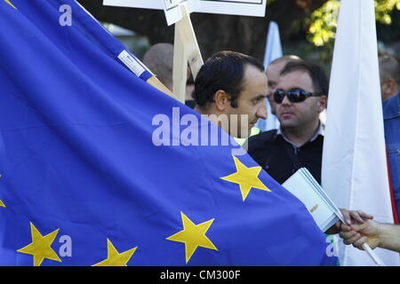 Demonstrator in eine große EU-Fahne gehüllt. Gewerkschaften aus mehreren anderen europäischen Ländern haben Briefe an Innenminister Tsvetan Tsvetanov, die Forderungen der bulgarischen Kollegen unterstützen gesendet. Sofia, Bulgarien; 23.09.2012. Bildnachweis: Johann Brandstatter / Alamy Live News Stockfoto