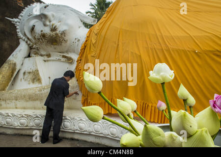 3. Oktober 2012 - gilt Ayutthaya, Ayutthaya, Thailand - ein Mann Blattgold für eine Reclining Buddha als ein Verdienst im Wat Yai Chaimongkhon in Ayutthaya. Wat Yai Chaimongkhon ist eines des wichtigsten Tempels in Ayutthaya und wurde 1357 gebaut. Ayutthaya ist die ehemalige kaiserliche Hauptstadt der damaligen Siam, heute Thailand. Ayutthaya wurde wurde um 1350 gegründet und der zweite Hauptstadt von Siam nach Sukhothai. Ayutthaya Lage zwischen China, Indien und dem Malaiischen Archipel gemacht Ayutthaya Handelszentrum der das Seengebiet. Um 1700 war Ayutthaya die größte Stadt der Welt mit einer Gesamtfläche von 1 Million Stockfoto