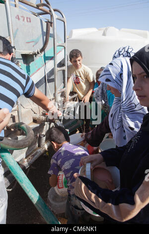 Azaz, Syrien. 17. Oktober 2012. Menschen sammeln Wasser von einem Lastwagen an der syrischen Flüchtlingslager an der Grenze mit der Türkei in A'zaz, Syrien am 17. Oktober 2012. Stockfoto