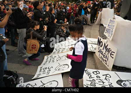 22. Oktober 2012, New York, NY, USA.  Am Union Square, einem afroamerikanischen Mädchen umgeben von Skizzen von Menschen, die von der Polizei getötet; Demonstranten wurden der 17. nationalen Tag der Protest gegen Polizeigewalt stoppen markieren. Stockfoto