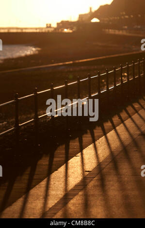 27. Oktober 2012 - Mumbles - Swansea - UK: lange Schatten bei Sonnenaufgang am Meer im kleinen Dorf von Mumbles in der Nähe von Swansea in Südwales früh auf eine knackige Herbstmorgen am letzten Tag der britischen Sommerzeit. Stockfoto