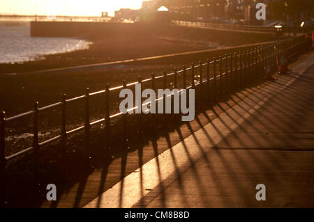 27. Oktober 2012 - Mumbles - Swansea - UK: lange Schatten bei Sonnenaufgang am Meer im kleinen Dorf von Mumbles in der Nähe von Swansea in Südwales früh auf eine knackige Herbstmorgen am letzten Tag der britischen Sommerzeit. Stockfoto