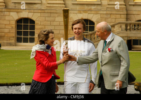 Derbyshire, UK. Freitag, 29. Juni 2012. Olympische Fackelträger, Ben Hope und der Herzog und die Herzogin von Devonshire halten eine London2012 Olympische Fackel trägt das Olympische Feuer auf dem South Lawn von Chatsworth House herrschaftlichen Haus. Chatsworth House ist der Sitz des Herzogs von Devonshire und ist Heimat der Cavendish-Familie seit 1549. Stockfoto