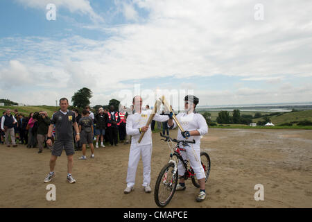 6. Juli 2012, Hadleigh Farm, Essex. Die Olympische Fackel durchläuft der Olympischen Mountainbike Ort wo Dan Jarvis die Fackel um einen Abschnitt des Rennens nimmt vor Übergabe an Läufer Kim Axford route und ab in Richtung Basildon und Grautöne. Das Wetter wurde zu trocken und sonnig, wie die Fackel an der Abendkasse gegen den neuesten Wettertrend nass, nass, nass ankam. Stockfoto