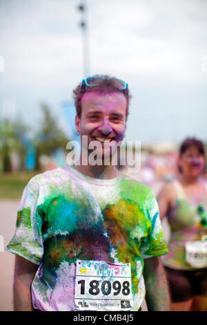 IOWA, USA. Sonntag, 8. Juli 2012. Mit leuchtenden Farben bedeckt, stellt ein Farbe mir Rad Läufer nach dem Rennen. Farbe mir Rad verbindet ein 5K Run/Walk mit geduscht mit bunten Maisstärke und Farbstoff und Vorteile der Special Olympics. Stockfoto